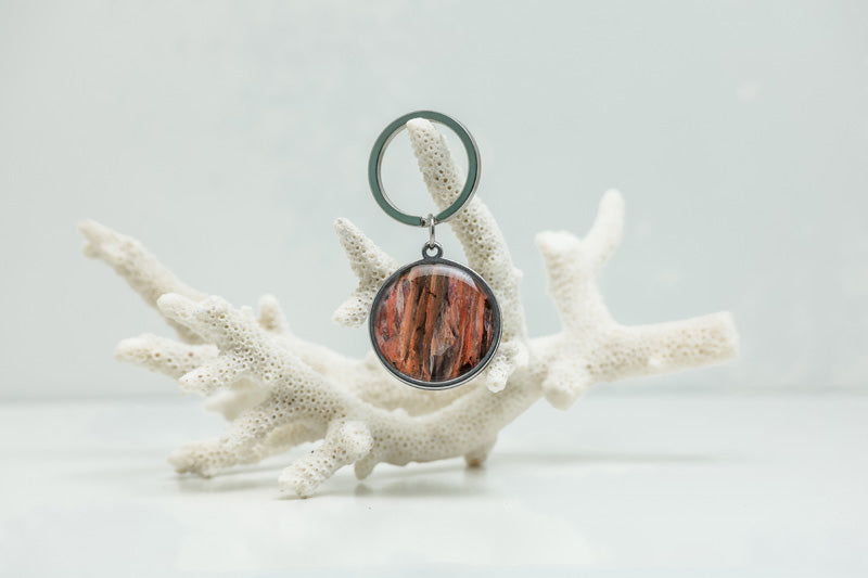 A Silver Keychain ring on white coral on a white background. 