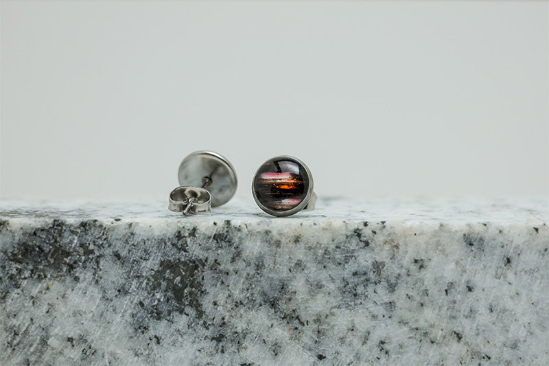 Small Studs on black and white marble on a white background.