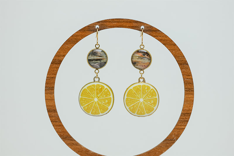 Coastal Capri Earrings on a circular wooden stand on a white background. 