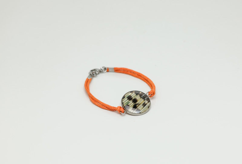 A Orange Cord Bracelet on a white background. 