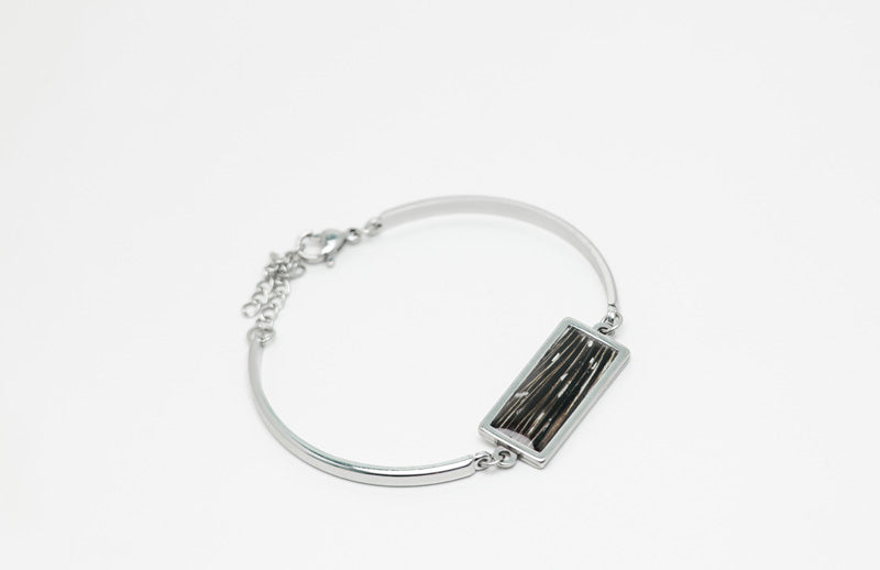 A silver Bar Bracelet on a white background.