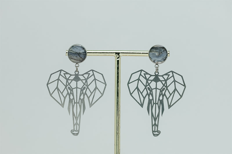 Geometric Elephant Earrings on a gold stand on a white background.