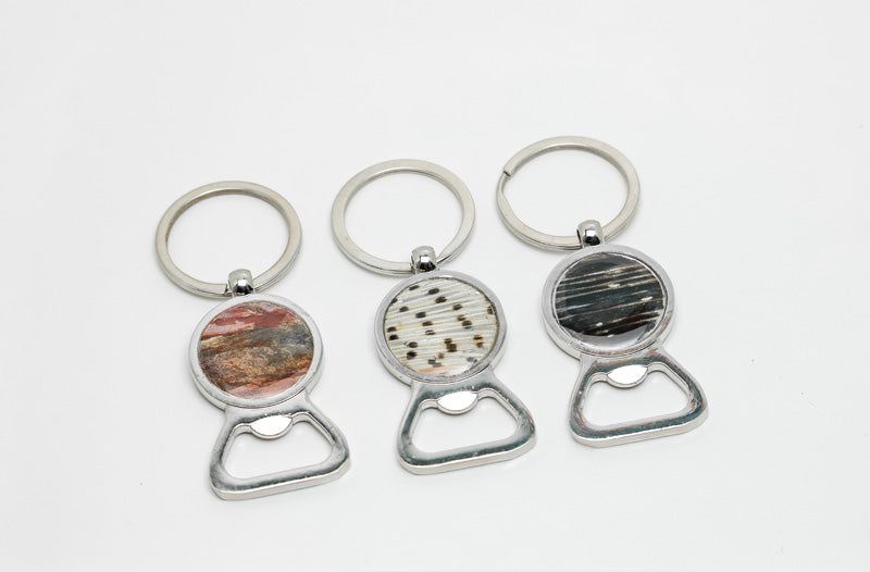 Three silver Bottle Opener Keychain rings on a white background.