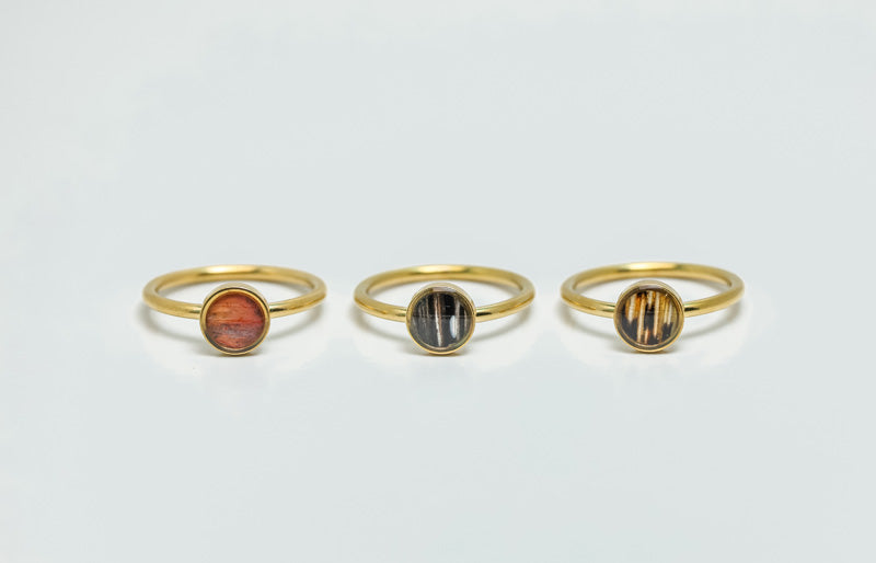 Three Mini Gold Rings on a white background.