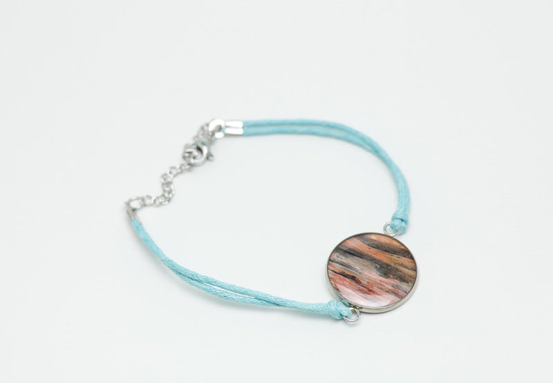 A Blue Cord Bracelet on a white background. 